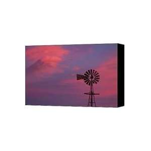  American Old Farm Water Pumping Windmill with a Sunset 