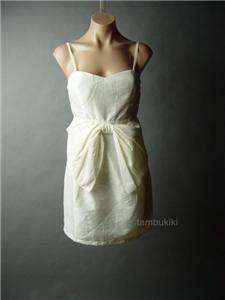 This ivory dress is elegant and sweetly feminine. An oversized bow 